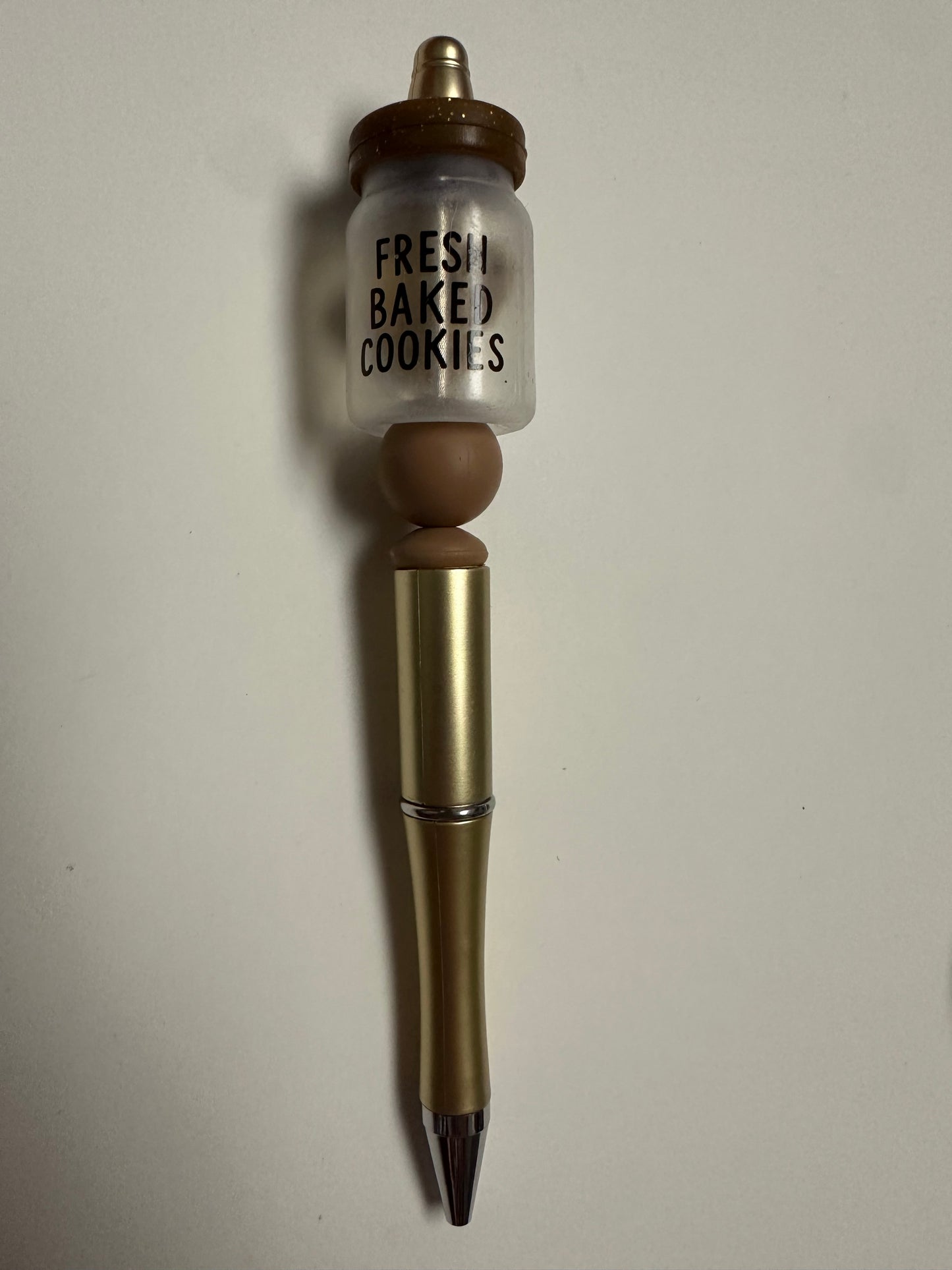 Gold pen with fresh baked cookies focal