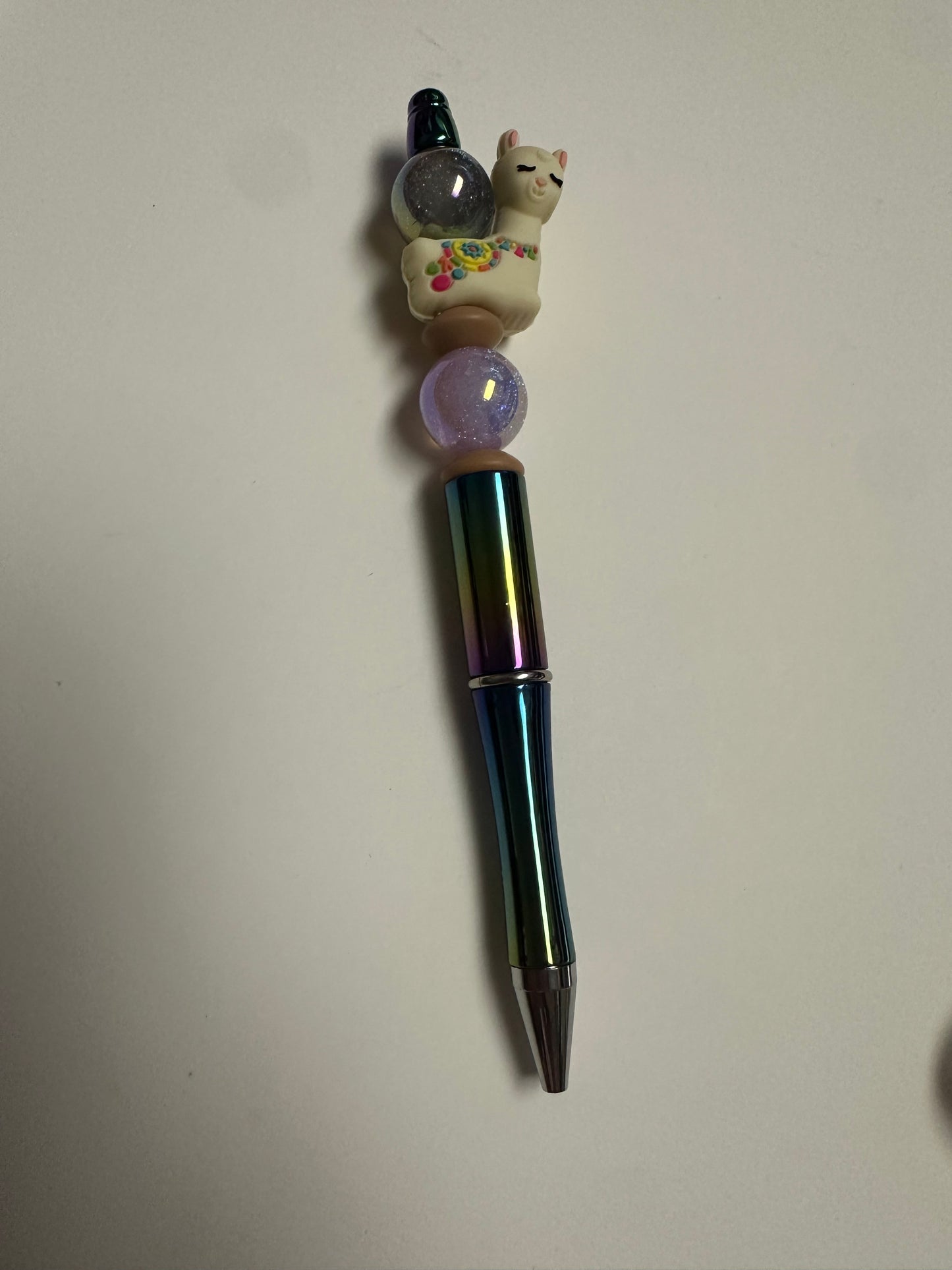 Multicolor beaded pen with llama focal