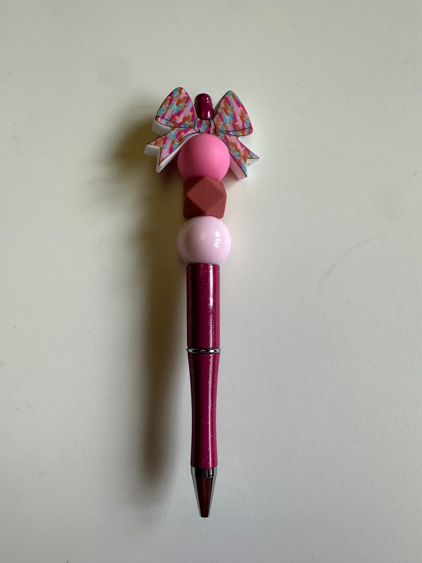 Beaded bow on a sparkle magenta pen