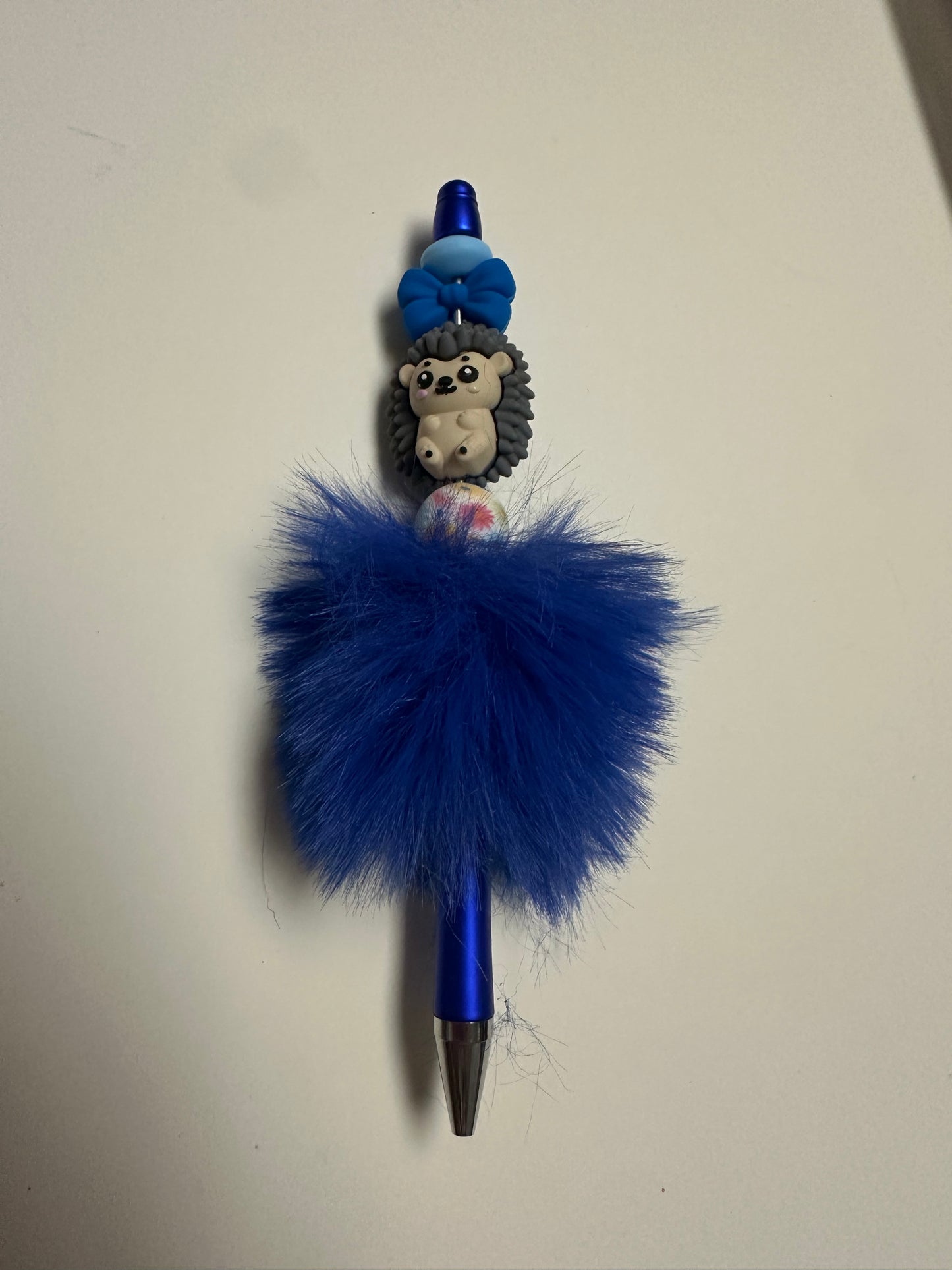 Blue fluffy beaded pen with a hedgehog focal