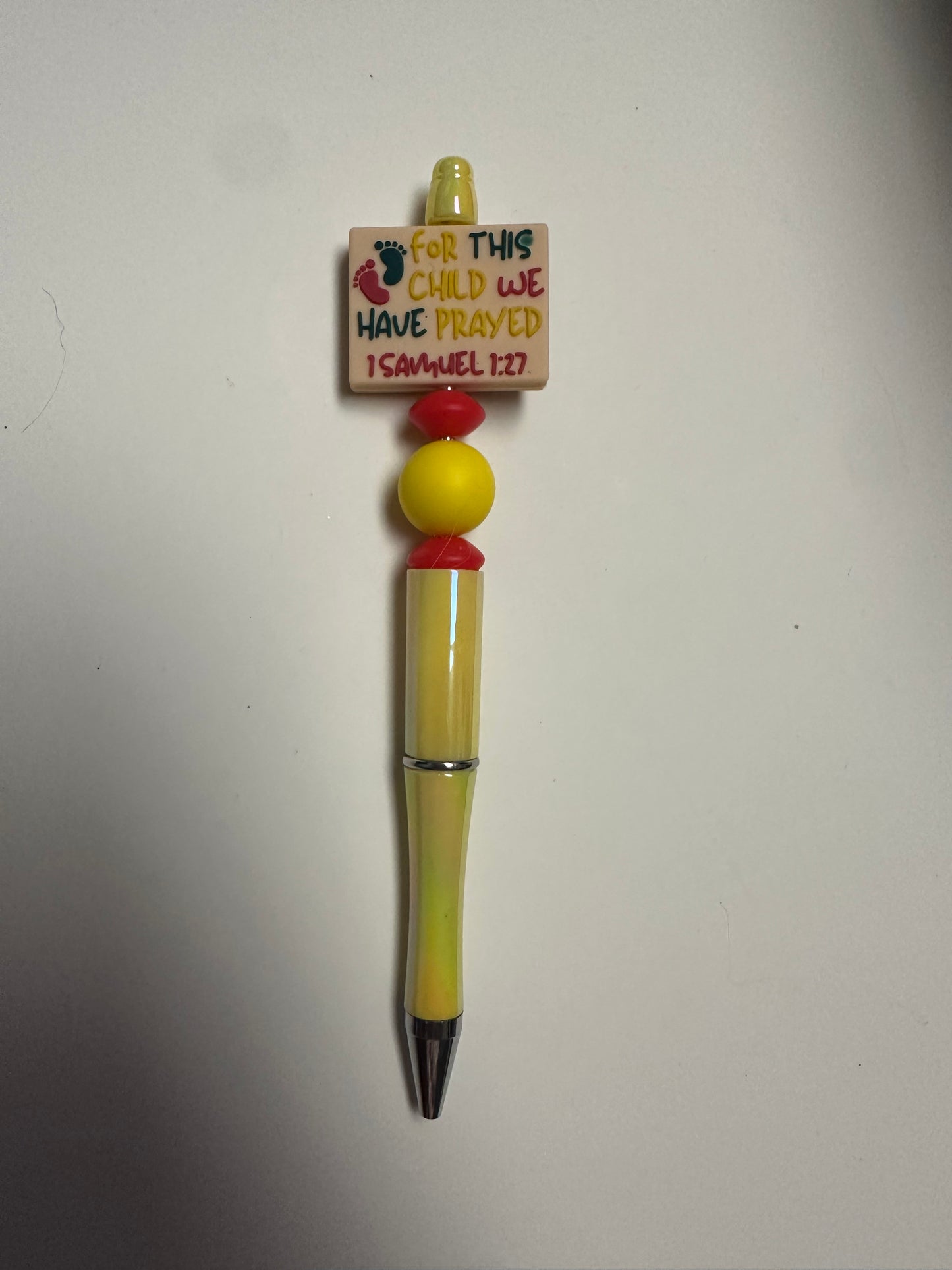 Yellow pen with for this child we have prayed focal