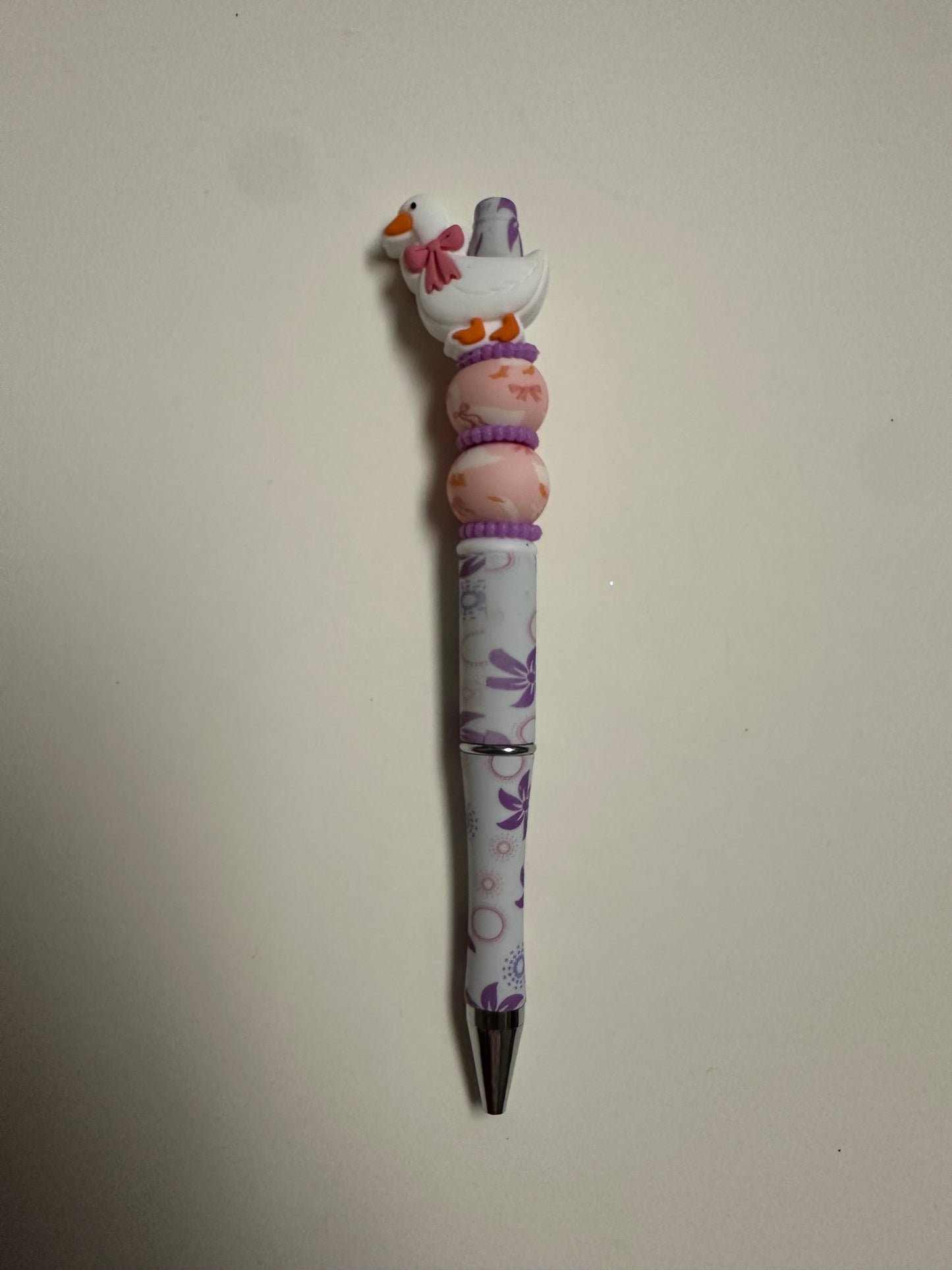Beaded pink bow goose with floral pen