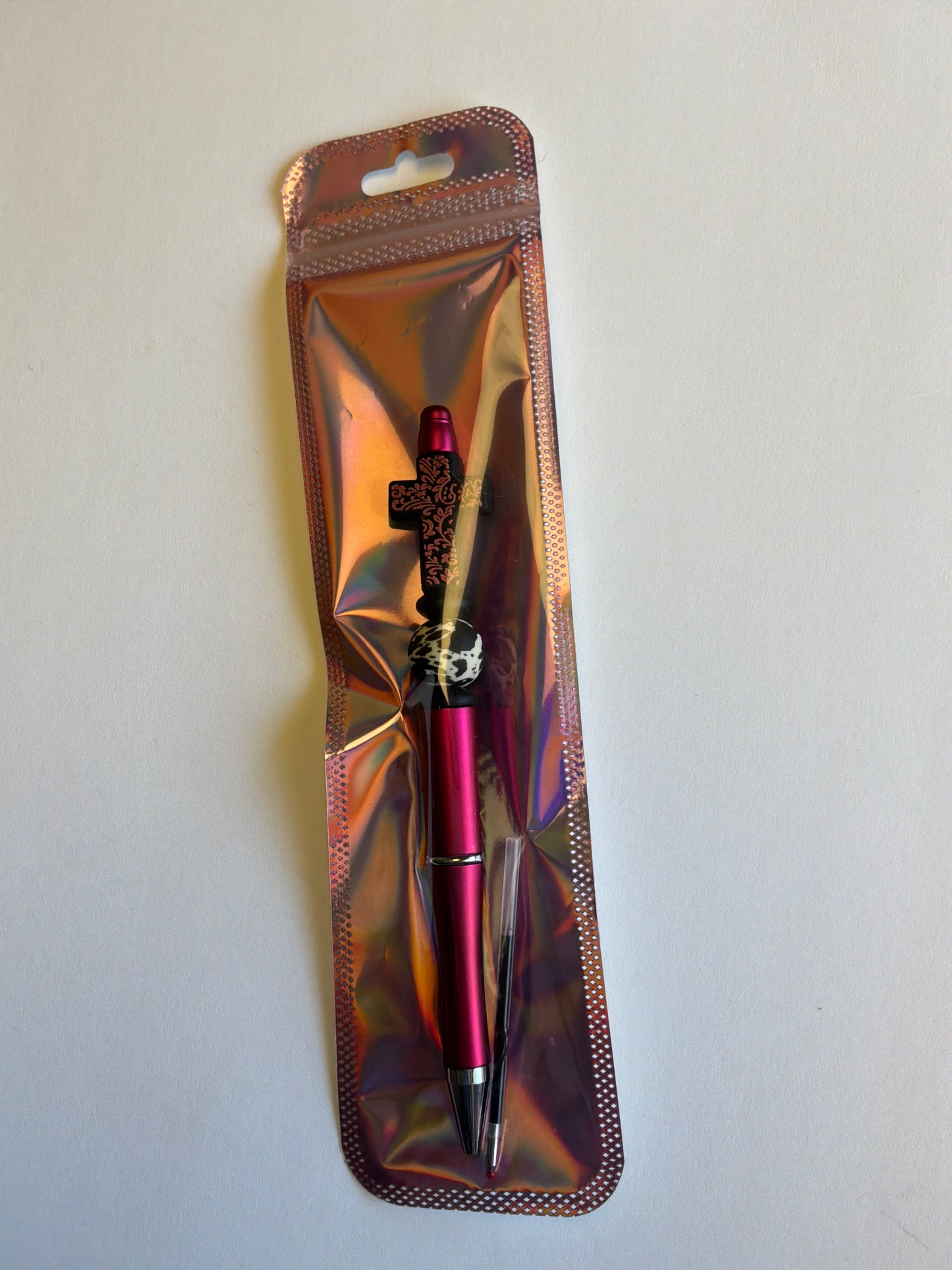 Beaded Brown leather cross on a metallic red pen