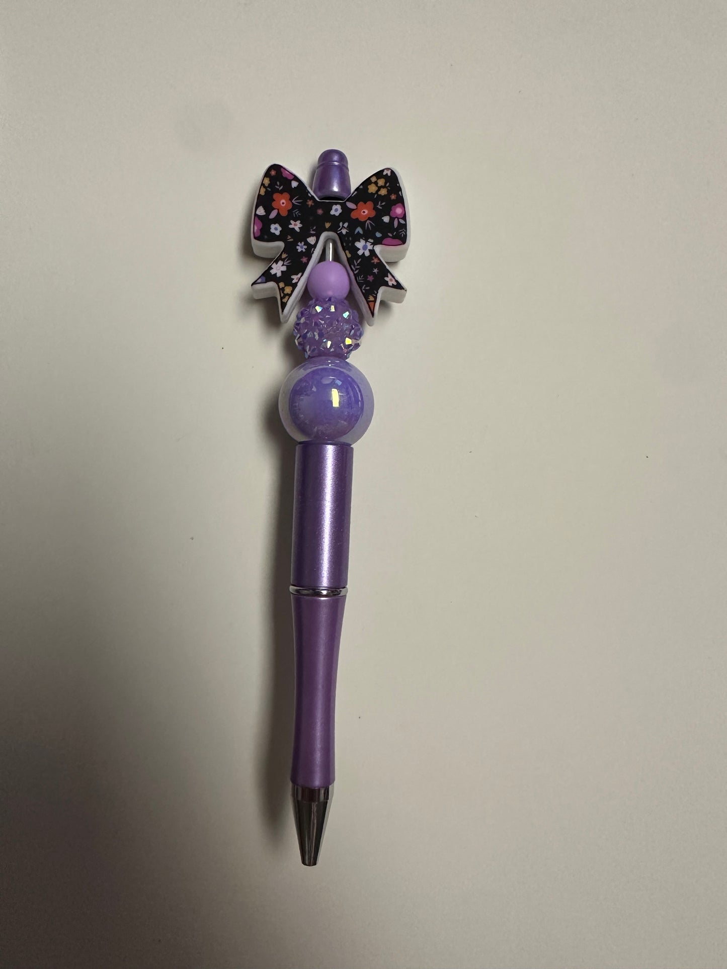 Light purple pen with black bow focal