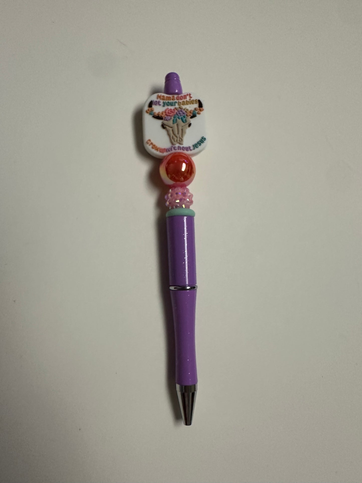 Beaded purple pen with Mama don’t let your babies focal