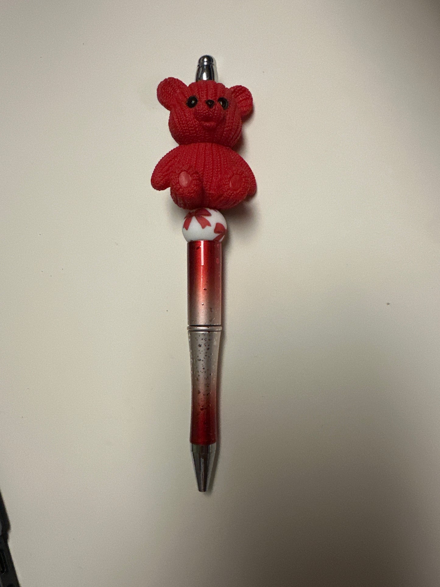 Beaded red bear with red and silver pen
